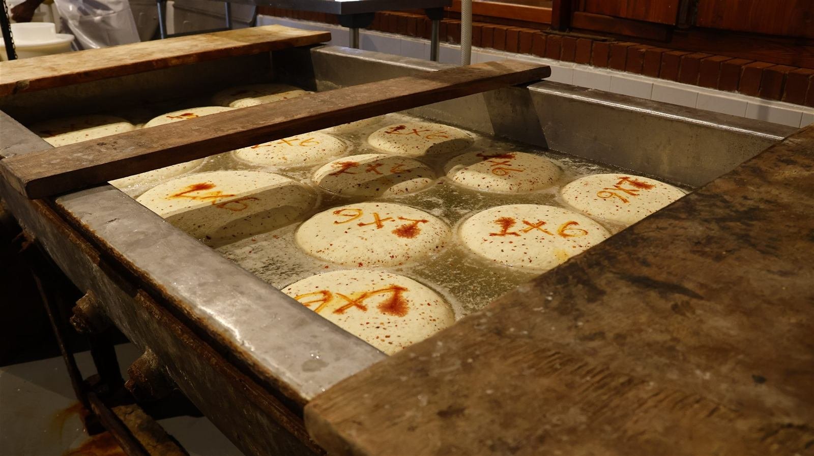 Wheels of Gouda in the brine bath at Van Gaalen Kaasmakerij