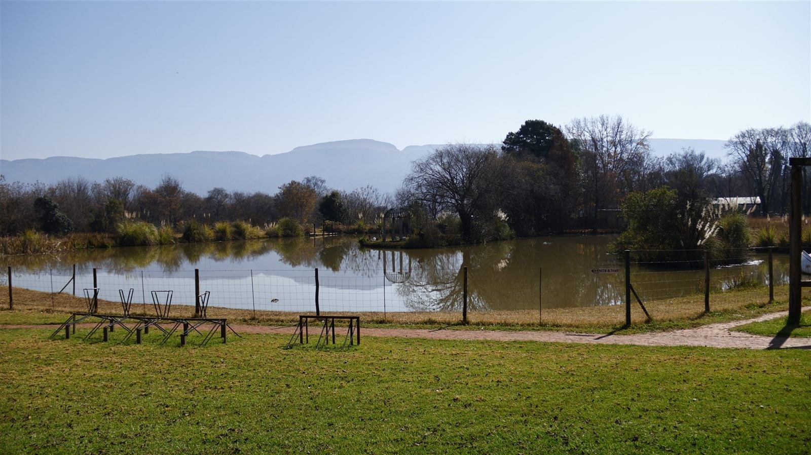 The dam and pastures at Van Gaalen beneath the Magaliesberg mountains
