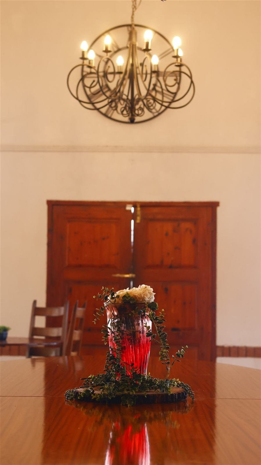 The private function room at Van Gaalen, a chandelier above a long table set for a celebration