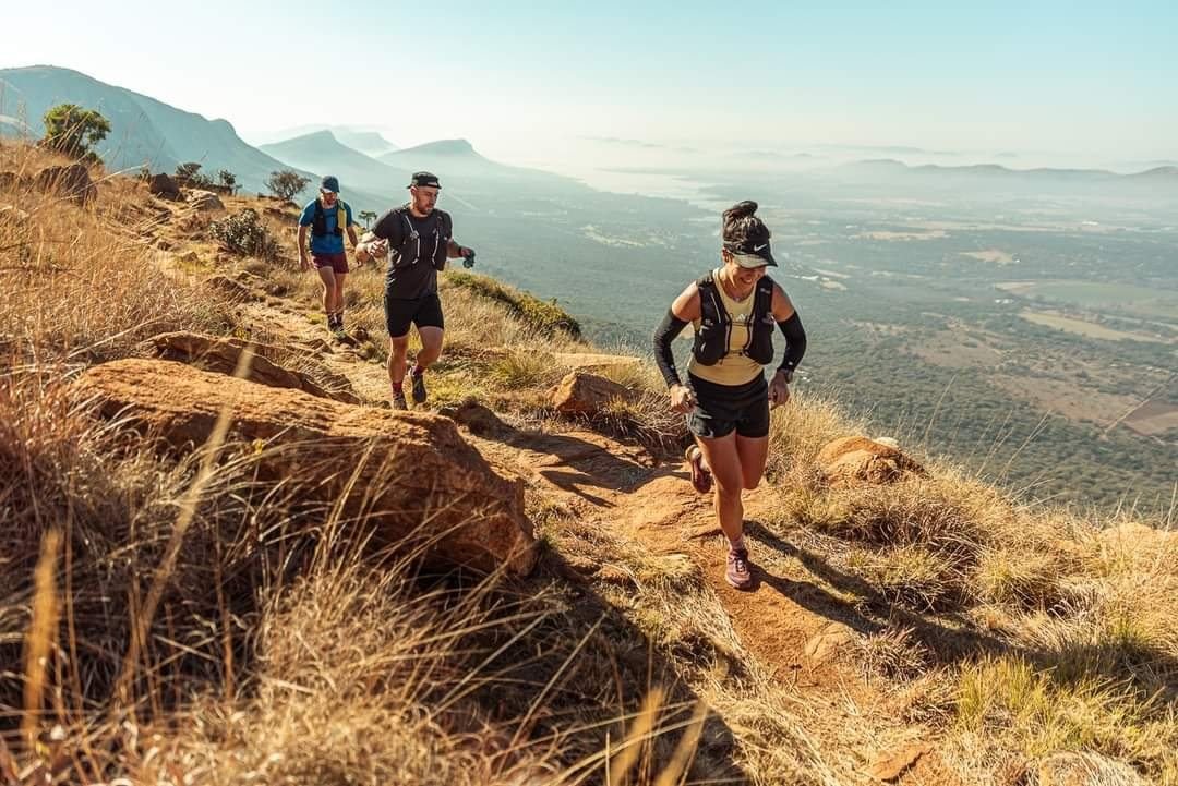 Trail runners climbing the escarpment above the Skeerpoort Valley at Van Gaalen