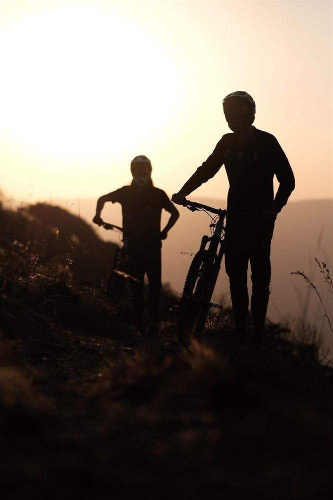 A rider silhouetted against the sunset on the Poffadder route at Van Gaalen